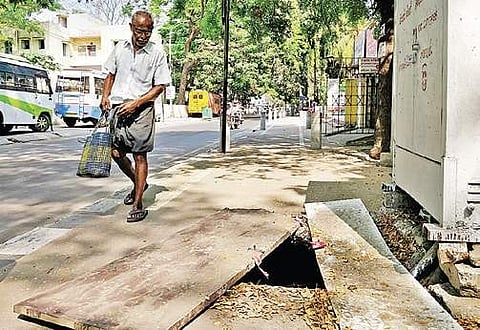 An elderly pedestrian observing the hole in the cycle path along Ramaswamy road in KK Nagar | Express