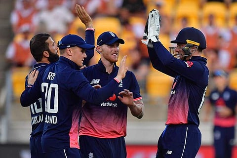 England's keeper Jos Buttler (R) celebrates New Zealand's Mark Chapman being caught with team mates Moeen Ali (L), Jason Roy (Centre L) and Ben Stokes (Centre R) during the third ODI cricket match. | AFP