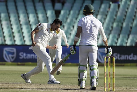 Australia's bowler Mitchell Starc, left, celebrates dismissing South Africa's captain Faf du Plessis‚ right, for 15 runs on day two of the first cricket test match between South Africa and Australia at Kingsmead stadium in Durban. (AP)