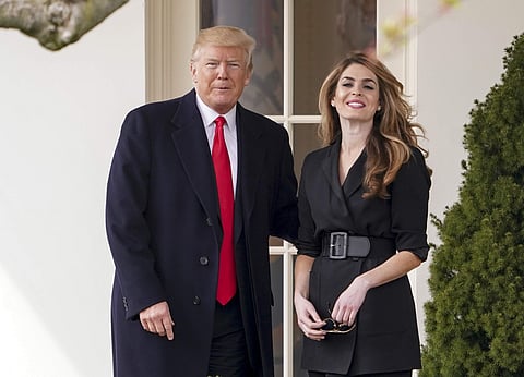 President Donald Trump poses for members of the media with White House Communications Director Hope Hicks on her last day | AP