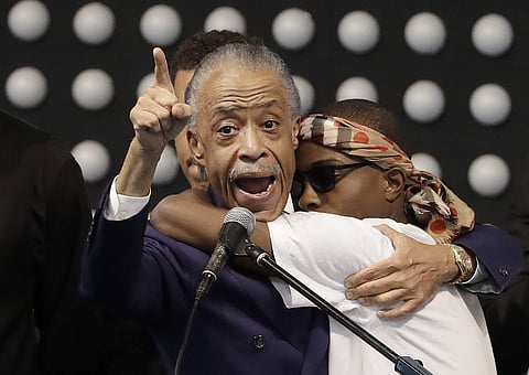 Rev. Al Sharpton, left, hugs Stevante Clark while speaking during the funeral services for police shooting victim Stephon Clark at Bayside Of South Sacramento Church in Sacramento | AP