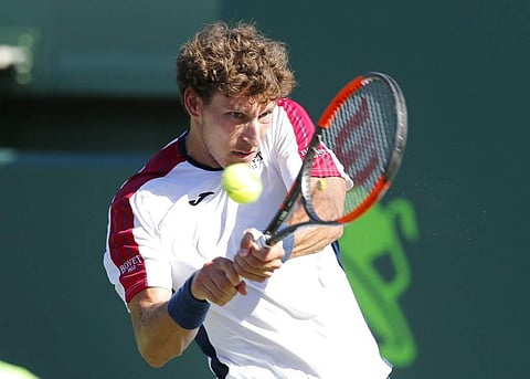 Pablo Carreno Busta, of Spain, hits a return to Kevin Anderson, of South Africa, during their quarterfinal match at the Miami Open tennis tournament. (AP)