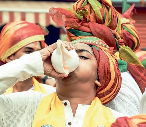 A Jain youth blows a conch during the ‘aheemsa march’ on the occassion of Mahaveer Jayanti in Vijayawada on Thursday | Express
