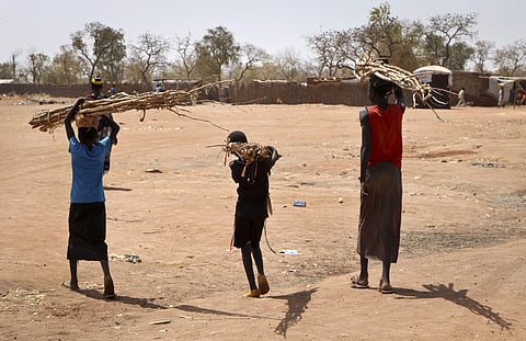 Sudanese refugee children carry wood in Yida, South Sudan. | AP
