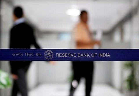 People walk past a barricade inside the Reserve Bank of India (RBI) headquarters in Mumbai, India June 7, 2017. (Photo: Reuters)