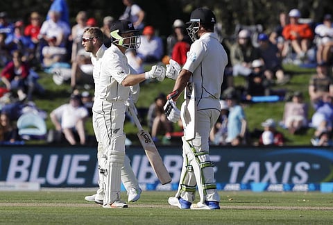 New Zealand's Colin de Grandhomme and teammate BJ Watling celebrate their hundred run partnership during play on day two of the second cricket test against England at Hagley Oval in Christchurch. (AP)