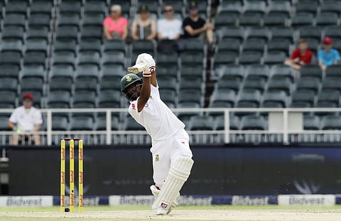 South Africa's batsman Temba Bavuma watches his shot on day three of the fourth cricket test match between South Africa and Australia at the Wanderers stadium in Johannesburg. | AP