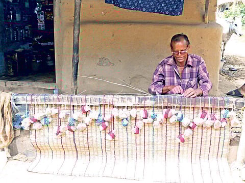 A man busy making traditional mat at a village in Kendrapara | Express