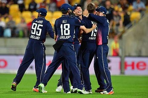 England's Chris Woakes (C) and teammates celebrate their victory in the third ODI cricket match between New Zealand and England at Westpac Stadium in Wellington on March 3, 2018. | AFP