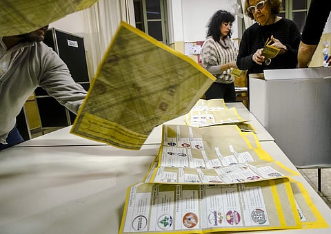 Scrutineers count votes in a polling station in Rome. (Photo | AP)