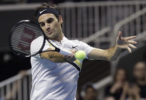 Roger Federer, of Switzerland, returns a shot against Jack Sock during an exhibition tennis match in San Jose. | AP