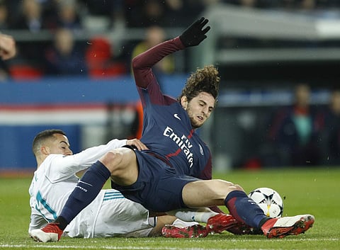 Real Madrid's Lucas Vazquez, left, stops PSG's Adrien Rabiot during the round of 16, 2nd leg Champions League soccer match. | AP