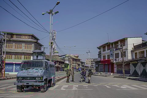 Paramilitary soldiers interrogate a Kashmiri motorcyclists before letting them go during restrictions in Srinagar. | AP
