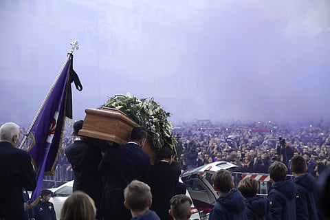 The coffin leaves the church in a purple smoke screen at the end of the funeral ceremony of Italian player Davide Astori in Florence. | AP