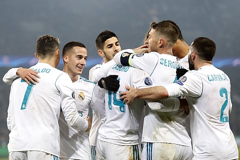 Real Madrid players celebrate scoring their second goal during the Champions League round of sixteen second leg soccer match against PSG. | AP
