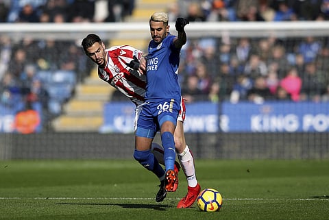 Stoke City's Geoff Cameron, left, and Leicester City's Riyad Mahrez battle for the ball during the English Premier League soccer match. | AP