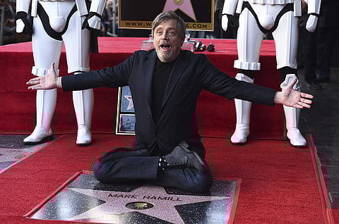 Mark Hamill poses with his star during a ceremony on the Hollywood Walk of Fame on Thursday, March 8, 2018 in Los Angeles. | AP