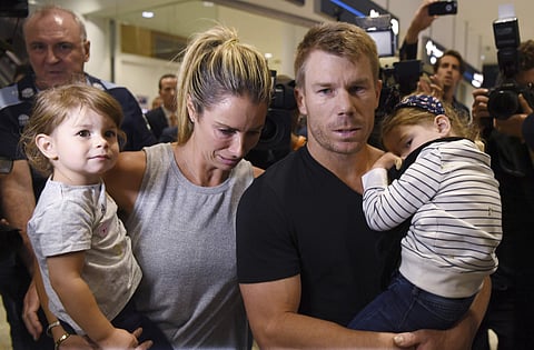 Disgraced Australian Cricket Vice Captain David Warner, second right, arrives with his wife Candice, second left, and their children at Sydney Airport, Thursday, March 29, 2018, after being sent home from South Africa. | Associated Press