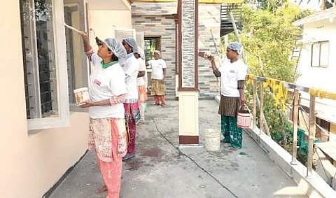 The members of Nirakootu engaged in painting a house