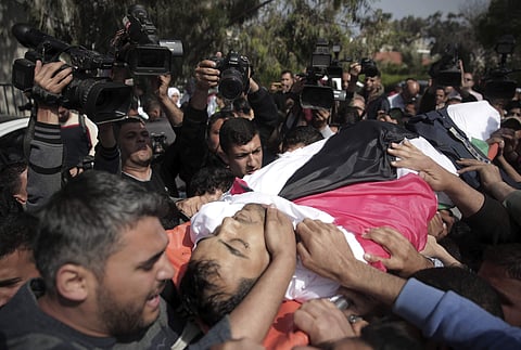 Mourners carry the body of Palestinian journalist Yasser Murtaja | AP