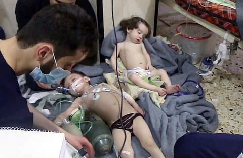File image made from video released by the Syrian Civil Defense White Helmets, shows medical workers treating toddlers following an alleged poison gas attack in the opposition-held town of Douma | AP