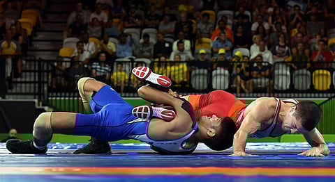 India's Rahul Aware wrestles with Canada's Steven Takahashi in the men's freestyle 57kg wrestling final match | PTI