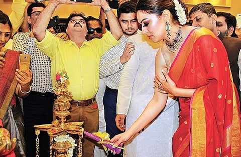 Actress Hansika Motwani lights the lamp at the launch