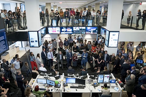 The Washington Post staff celebrate after they win two pulitzer prizes in Washington. (AP)