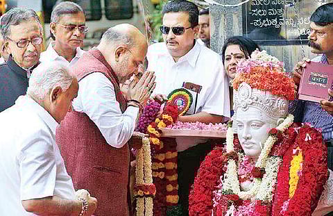 BJP national president Amit Shah and BJP state president B S Yeddyurappa paying floral tributes to a Basava statue on the occasion of Basava Jayanthi in Bengaluru on Wednesday. | Express
