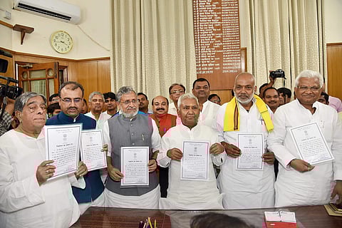 Newly elected Bihar legislative council members Bihar Deputy CM Sushil Kumar Modi, Mangal Pandey, Sanjay Paswan from BJP, RJD state president Ramchandra Purbe, Santosh Manjhi, JD U 's Khalid Anshari and Ram Ishwar Mahto show their certificates at Bihar As