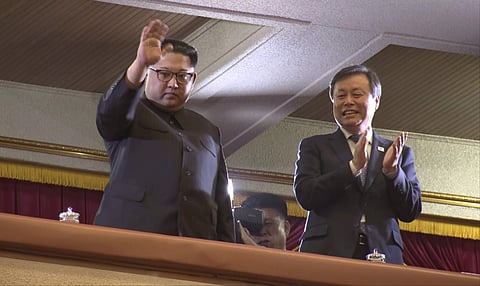 In this Sunday, April 1, 2018, image from video, North Korean leader Kim Jong Un, left, waves as South Korean Culture, Sports and Tourism Minister Do Jong-whan claps during a performance by a South Korean art troupe in Pyongyang, North Korea. | Associated