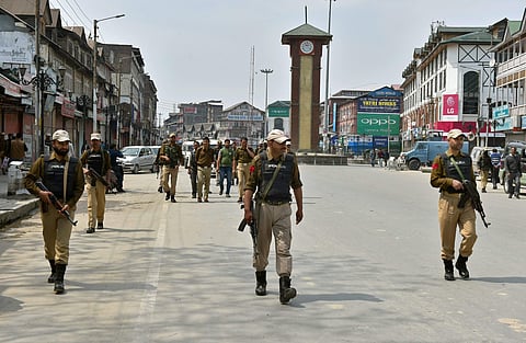 Police personnel stand guard at Lal Chowk in Srinagar on Monday. (PTI)