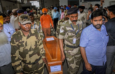 Army jawans carry a casket containing remains of one of the Indians abducted by the Islamic State group in 2014 that were found in a mass grave outside Mosul in Amritsar on Monday. (PTI)