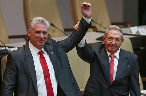 Cuba's outgoing President Raul Castro (right) and new President Miguel Diaz-Canel (Left) raise their arms in unison. (Photo | AP)