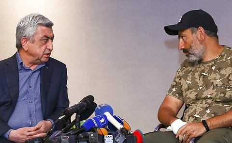 Armenian PM Serzh Sarkisian, left, with protest leader Nikol Pashinian (AP)