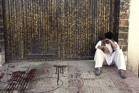 A relative of a victim cries outside a voter registration center which was attacked by a suicide bomber in Kabul. (AP)