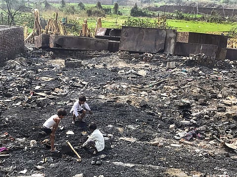 Children searching for their belongings in the charred debris of their homes a week after a Rohingya camp caught fire in Sarita Vihar in New Delhi. | PTI