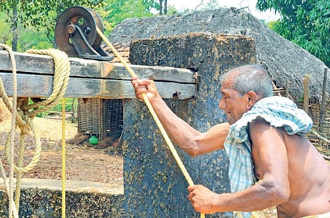 Seventy-year-old Govind Gaonkar draws water from one of the only two wells near Maigini village | D Hemanth