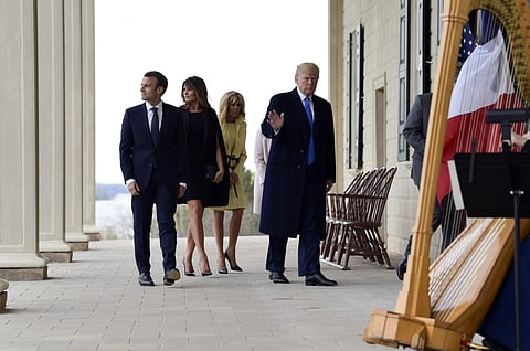 President Donald Trump, right, waves as he walks with French President Emmanuel Macron, left, first lady Melania Trump, second from left, and Brigitte Macron, second from right, during a visit and private dinner at George Washington's Mount Vernon estate