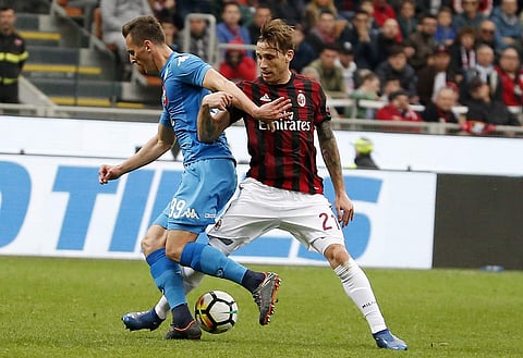 AC Milan's Lucas Biglia, right, challenges for the ball with Napoli's Arkadiusz Milik during the Serie A soccer match between AC Milan and Napoli at the San Siro stadium in Milan, Italy, Sunday, April 15, 2018. | AP