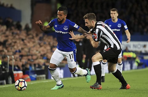 Everton's Theo Walcott, left, and Newcastle United's Paul Dummett battle for the ball during the English Premier League soccer match between Everton and Newcastle United at Goodison Park, Liverpool, England, Monday, April 23, 2018. | AP