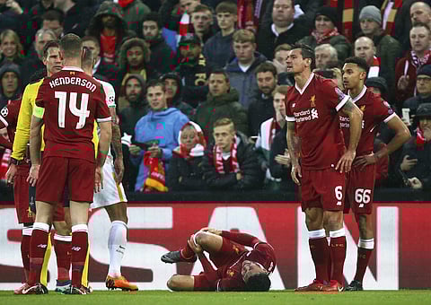 Liverpool's Alex Oxlade-Chamberlain grimaces on the ground after getting injured during the Champions League semifinal, first leg, soccer match between Liverpool and AS Roma at Anfield Stadium, Liverpool, England, Tuesday, April 24, 2018. | AP