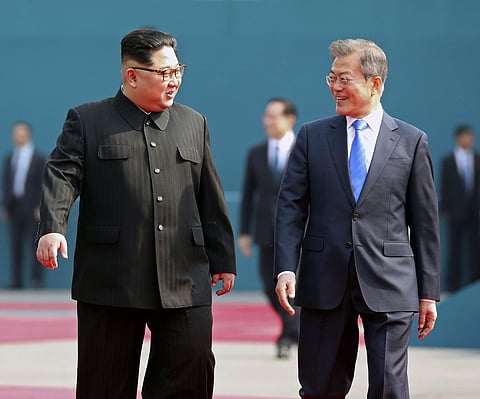 North Korean leader Kim Jong Un, left, talks with South Korean President Moon Jae-in, right. (File | AP)