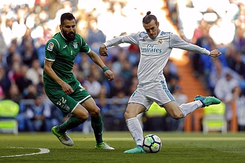 Real Madrid's Gareth Bale, right, shoots the ball next to Leganes' Dimitrios Siovas during a Spanish La Liga soccer match between Real Madrid and Leganes at the Santiago Bernabeu stadium in Madrid. | AP