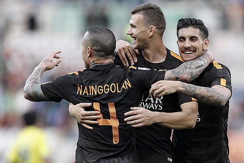 Roma's Edin Dzeko, center, celebrates with teammates Radja Nainggolan, left, and Lorenzo Pellegrini after scoring, during the Serie A soccer match between Roma and Chievo Verona, at the Rome Olympic Stadium, Saturday, April 28, 2018. | AP