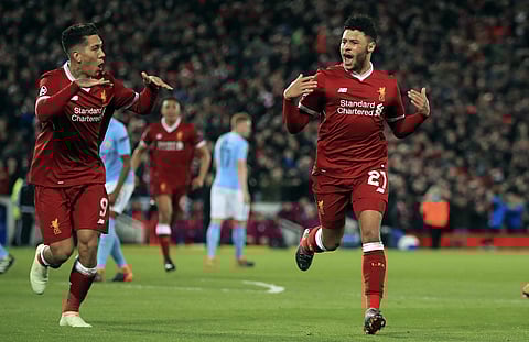 Liverpool's Alex Oxlade-Chamberlain, right, celebrates after scoring his side's second goal of the game during the Champions League quarter final, first leg soccer match between Liverpool and Manchester City at Anfield. |AP