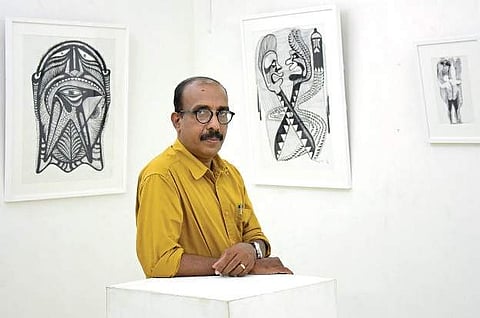 Baiju Dev in front of his paintings at Vyloppilly Samskrithi Bhavan in Thiruvananthapuram B P Deepu