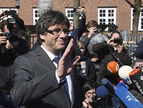 Former Catalan leader Carles Puigdemont greets supporters after he was released on bail from the prison in Neumuenster, northern Germany, Friday, April 6, 2018. | AP