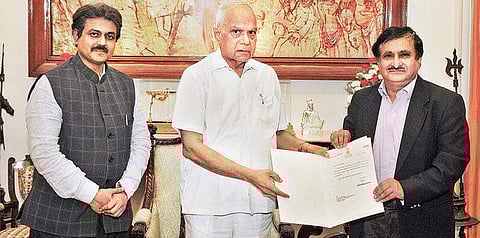 Governor Banwarilal Purohit giving appointment order to M K Surappa as the Vice-Chancellor of Anna University, in the city on Thursday | Express