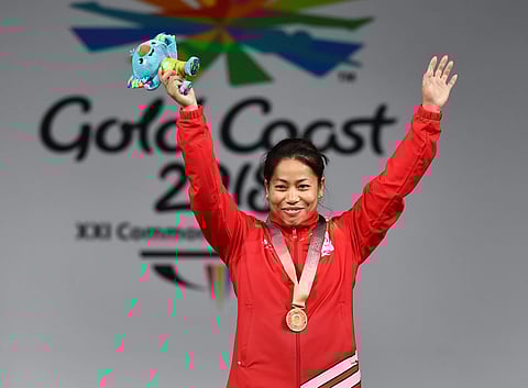 Gold medalist Indian weightlifter Sanjita Chanu poses for a photo during the medal ceremony of women's 53kg Weightlifting event during the Commonwealth Games 2018 in Gold Coast. | PTI